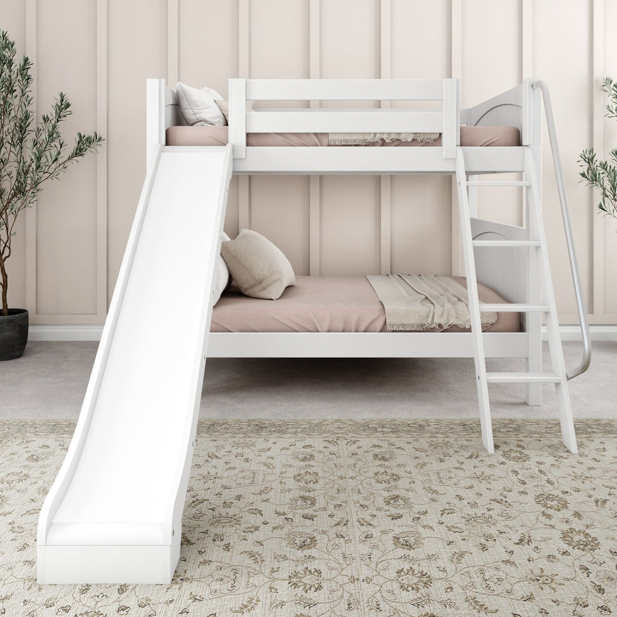 White twin loft bed with slide and ladder, featuring soft pink bedding and an elegant neutral area rug in a cozy, modern bedroom setup.