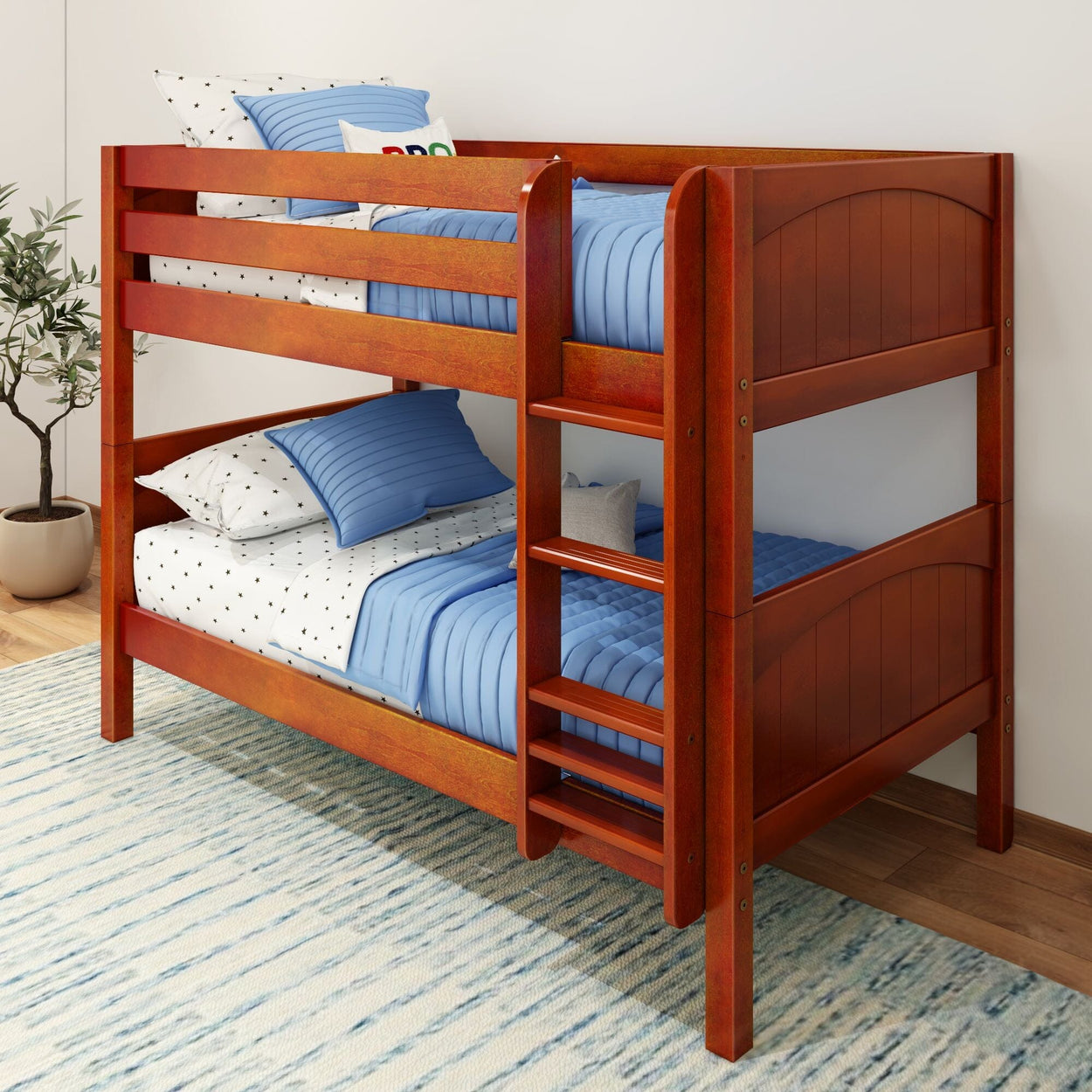 Kids wooden bunk bed with blue bedding and a ladder in a cozy bedroom setting.