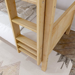 Wooden bunk bed ladder and bedding in a cozy bedroom setting.
