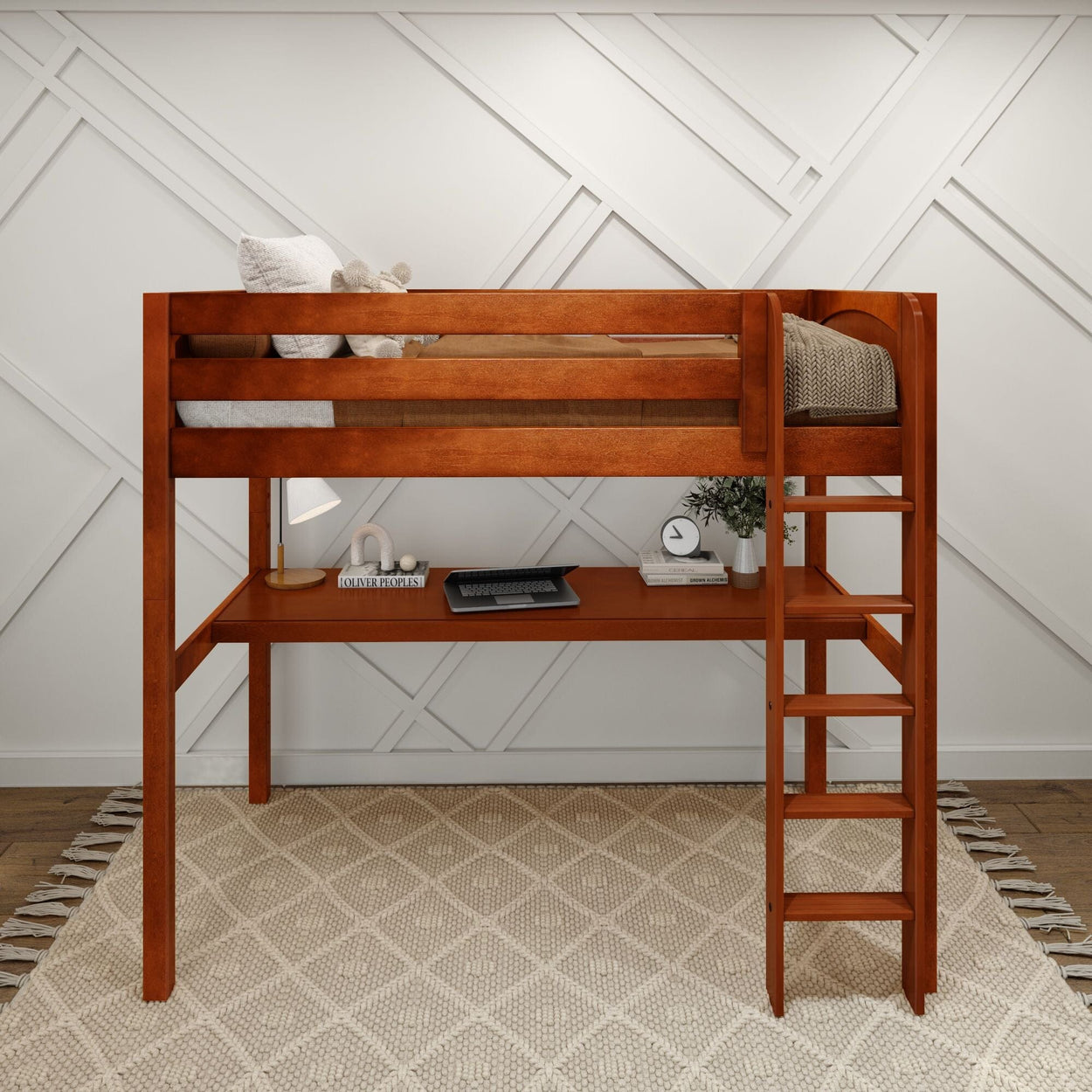 Lofted wooden bunk bed with ladder and desk, featuring a cozy setup with decor items on a white and beige geometric patterned rug.