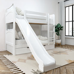 White wooden twin-over-twin bunk bed with slide, ladder and under-bed storage drawers in bright modern kids' bedroom with rug and potted plant