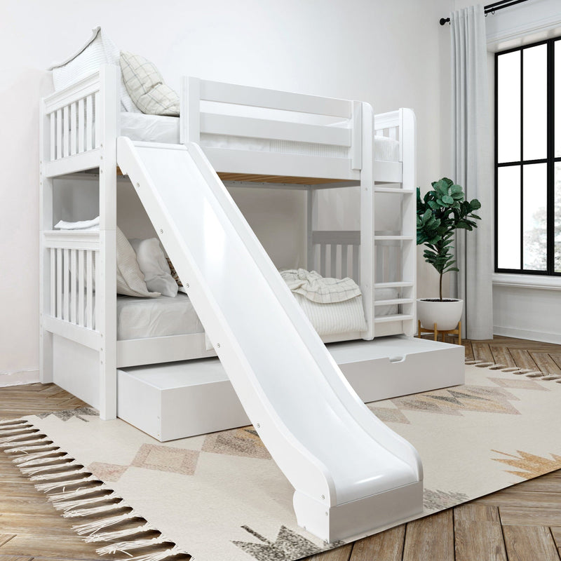 White wooden twin-over-twin bunk bed with slide, ladder and under-bed storage drawer in a modern kids' bedroom with large window and plant