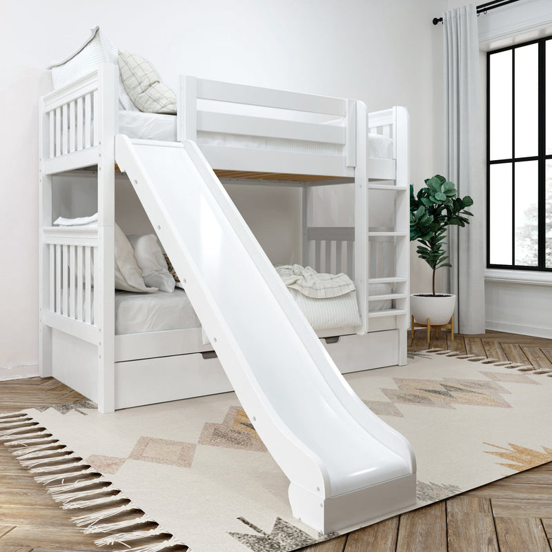 White wooden twin-over-twin bunk bed with slide and ladder in bright modern kids bedroom, built-in storage drawers, neutral geometric rug and potted plant