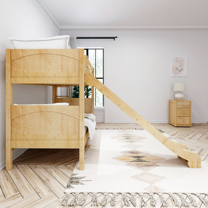 Wooden bunk bed with angled ladder in a bright minimalist kids' bedroom with neutral decor, patterned rug, nightstand lamp and window