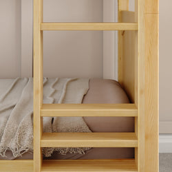Wooden bunk bed ladder next to a neatly made bed with a soft beige blanket.