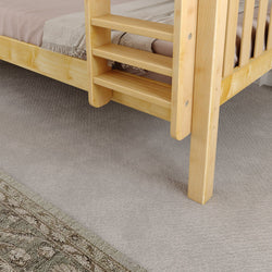 Wooden ladder-style bed with woven blanket on carpet floor, ideal for cozy bedroom decor.