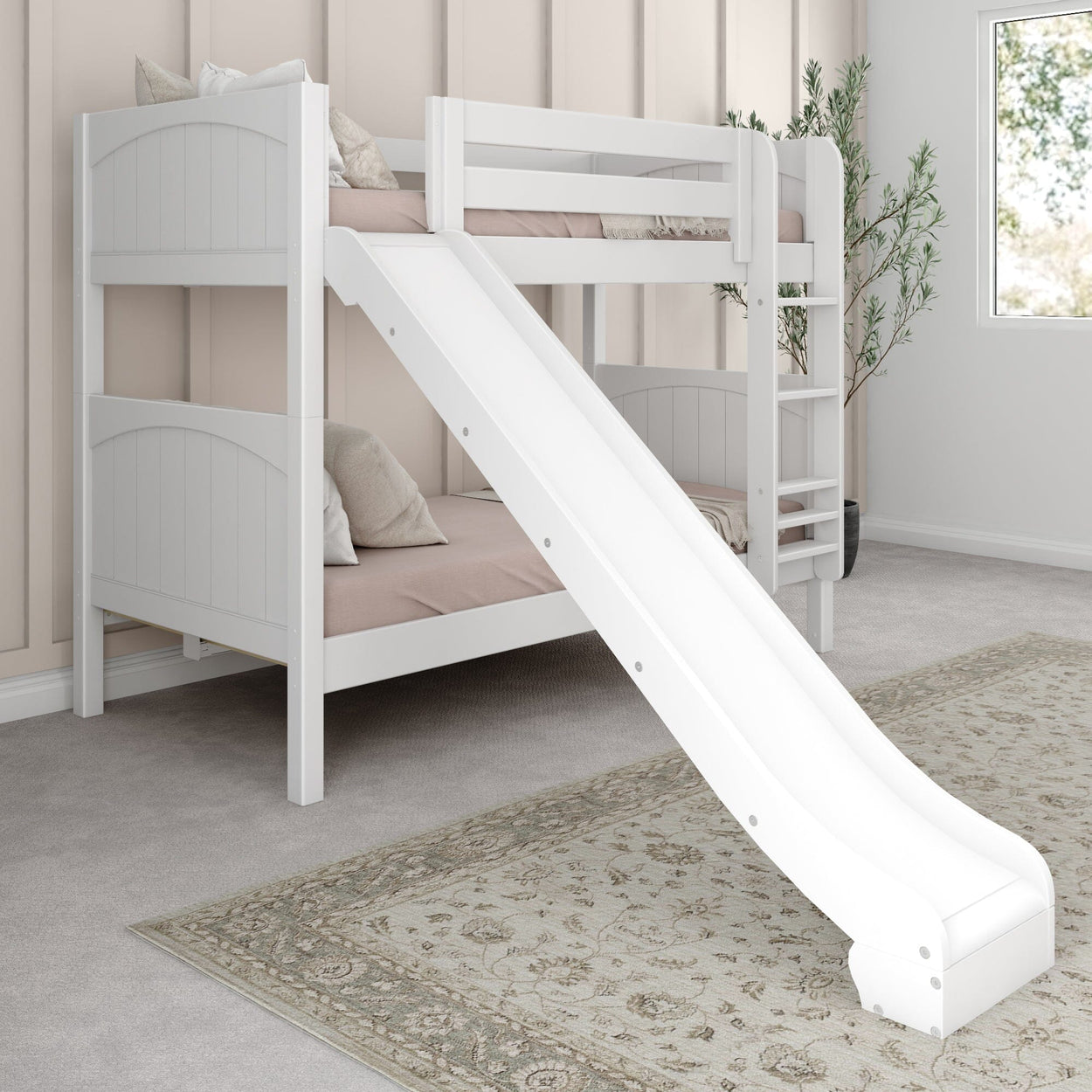 Children's white bunk bed with slide, cozy pillows, and elegant rug in a light-filled bedroom.