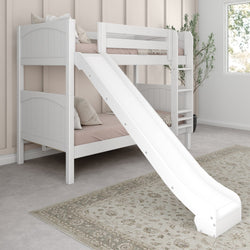 Children's white bunk bed with slide, cozy pillows, and elegant rug in a light-filled bedroom.