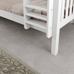 White wooden loft bed with ladder on carpeted floor featuring a patterned rug.