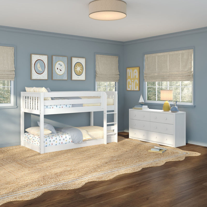 Kids bedroom with white bunk bed, blue walls, linen Roman shades, framed nursery art, white dresser, woven jute rug and table lamp