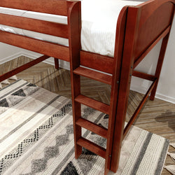 Close-up of red-brown wooden loft bed ladder attached to a twin loft bed over a patterned area rug and herringbone wood floor in a modern bedroom