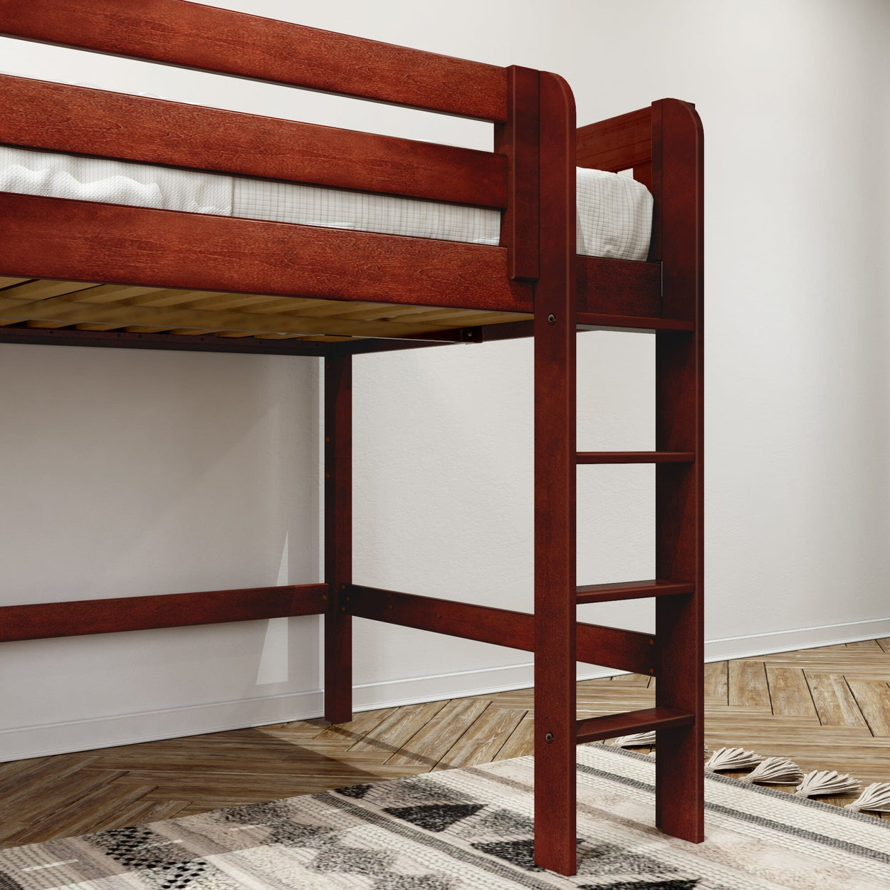 Wooden loft bed with ladder and twin mattress, dark cherry finish, herringbone hardwood floor and geometric rug in a minimalist bedroom