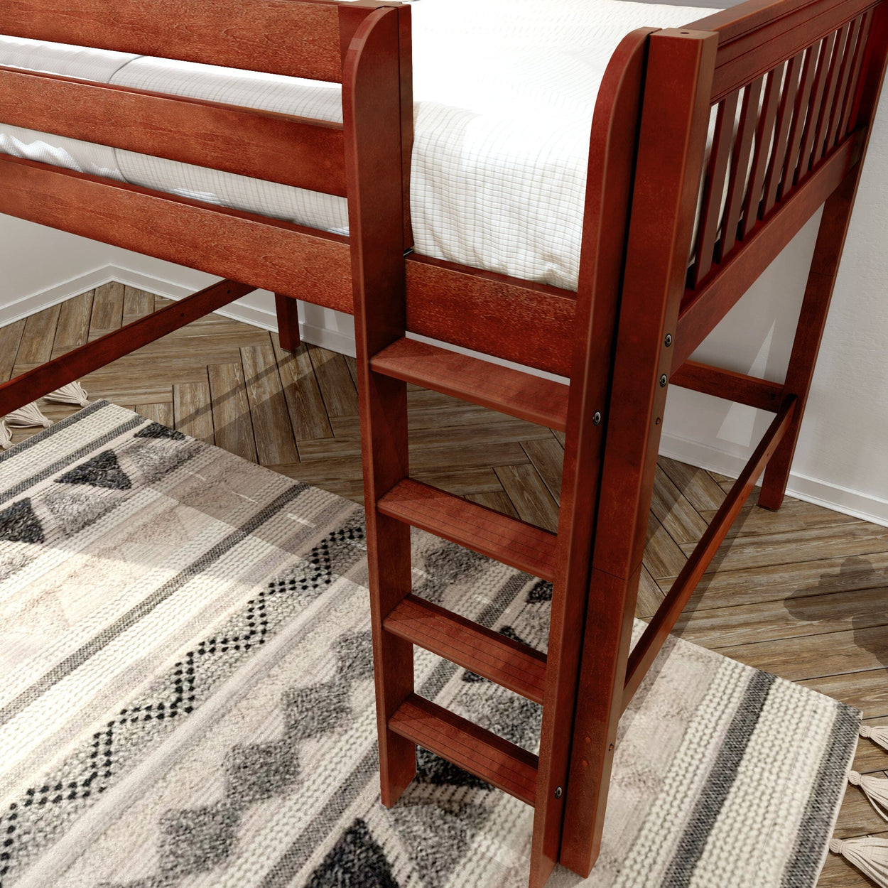 Solid cherry wood loft bed ladder and twin mattress over herringbone hardwood floor with patterned boho rug in children's bedroom