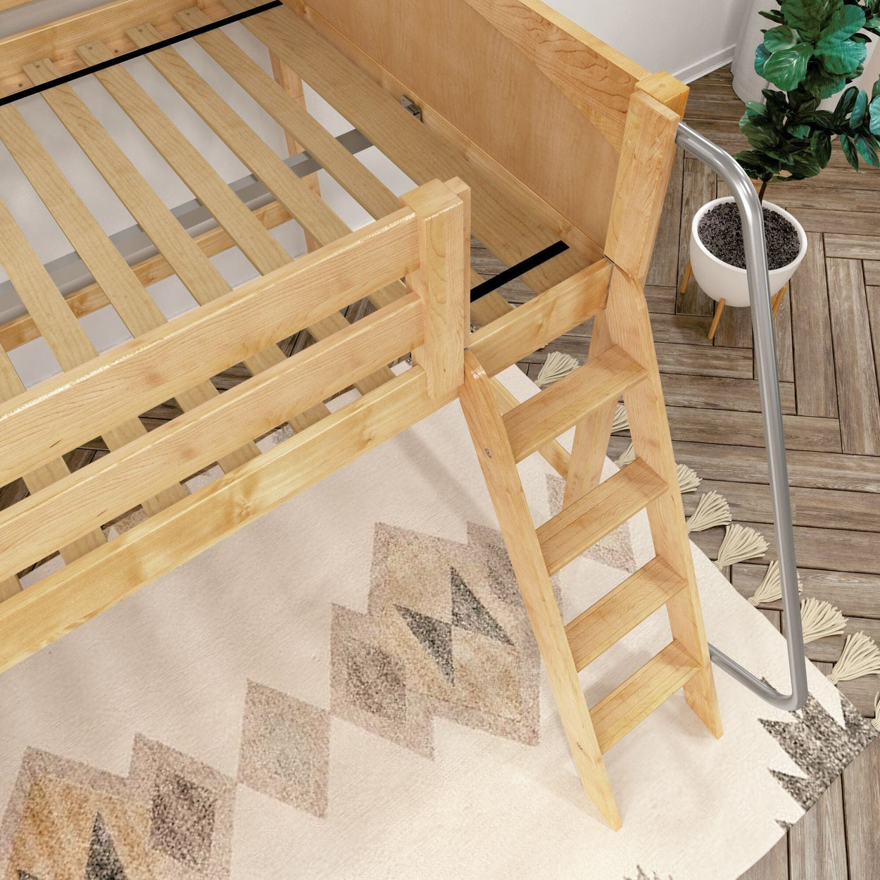 Natural wood loft bed with ladder and slatted mattress support above geometric area rug in modern bedroom — space-saving kids bunk bed