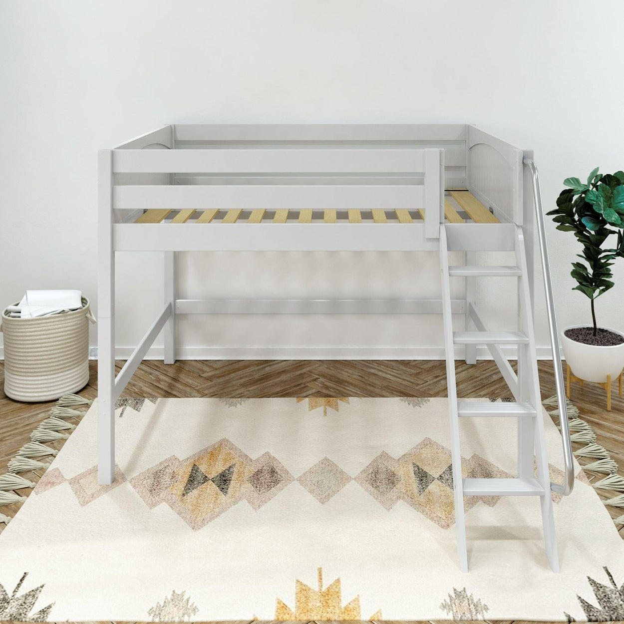 White twin loft bed with ladder and wooden slats in modern kids' bedroom with patterned rug, plant, and woven storage basket