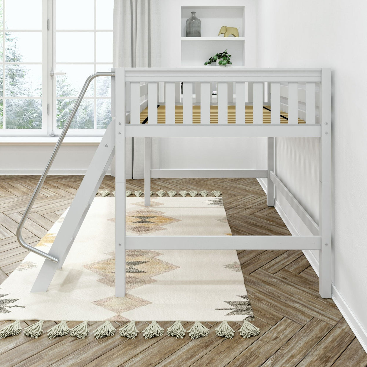 White children's loft bed with metal ladder above tassel-trim geometric area rug on herringbone hardwood floor in bright minimalist nursery with large window