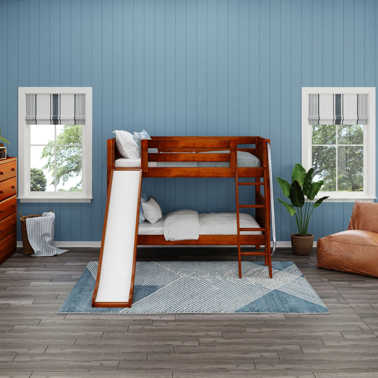 Bunk bed with slide in modern kids' room with blue walls and hardwood floors.