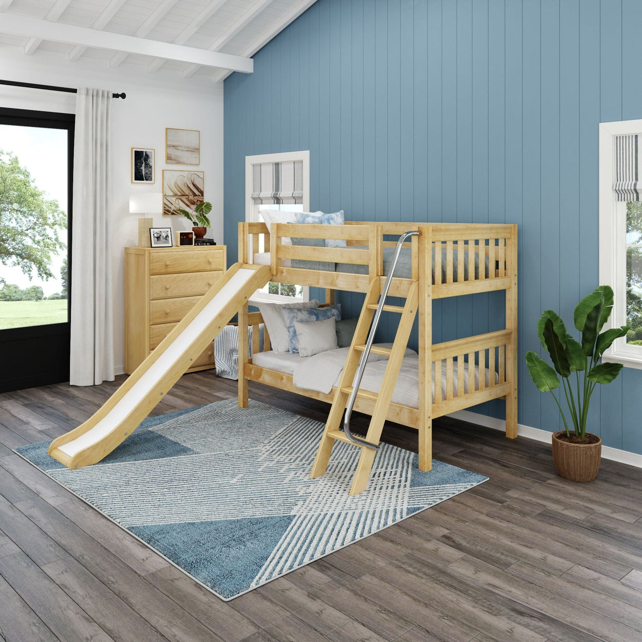 Children's bedroom with wooden bunk bed featuring a slide and ladder, modern decor, and blue accent wall.