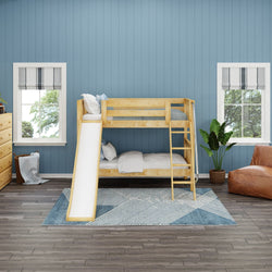 Wooden bunk bed with slide in a blue-themed kids' room featuring decorative pillows, potted plant, and geometric rug.