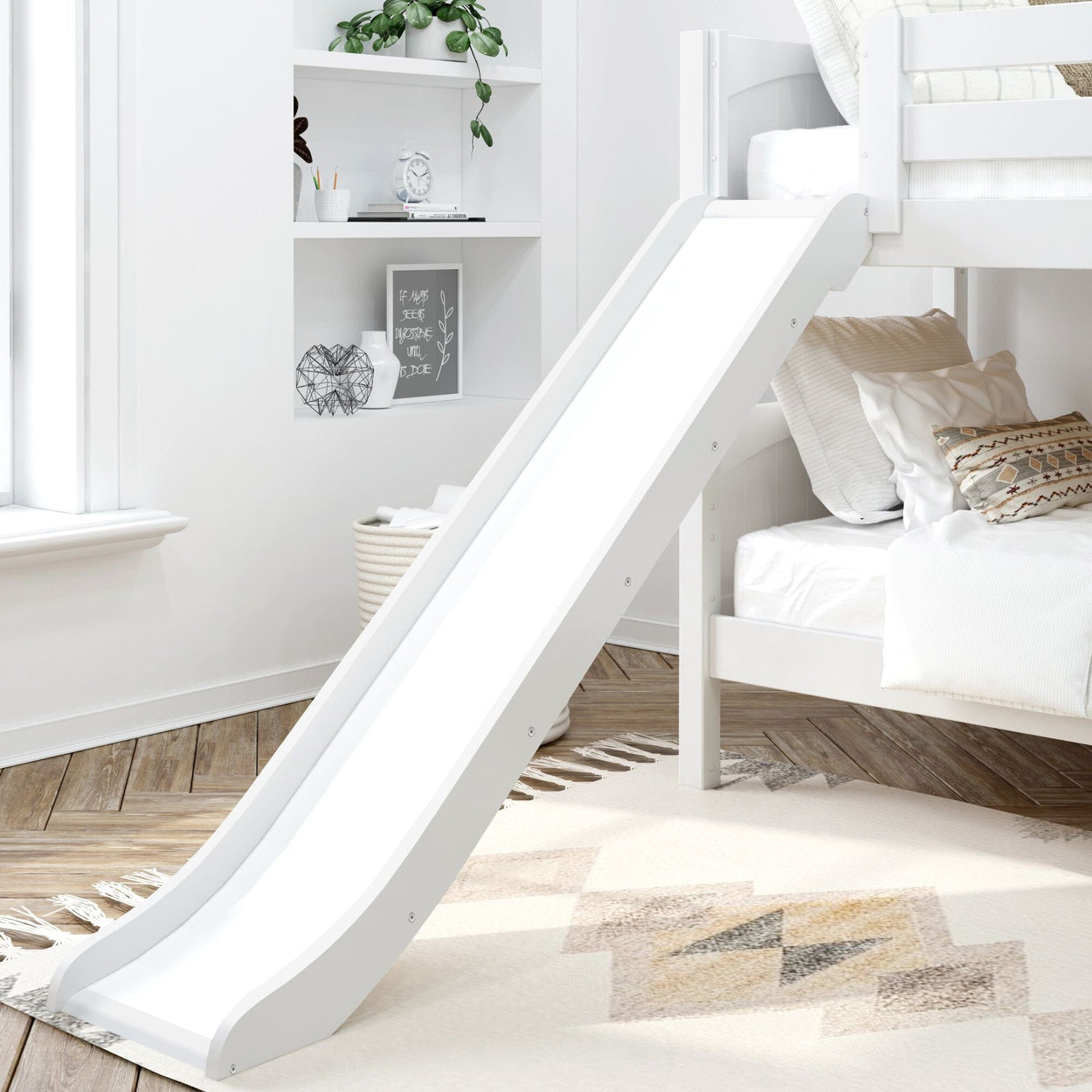 Children's bunk bed with slide in modern white bedroom featuring stylish decor and cozy bedding.