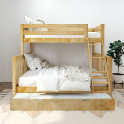 Natural wooden bunk bed with ladder and pull-out trundle drawer, white striped bedding and decorative pillows in a bright modern kids' bedroom with potted plant