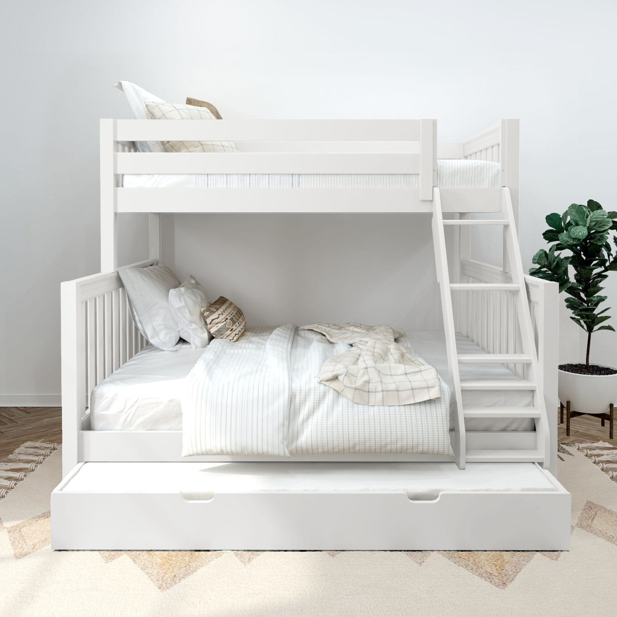 White wooden bunk bed with ladder and pull-out trundle in a modern neutral bedroom with white linens, decorative pillows, indoor plant and textured rug