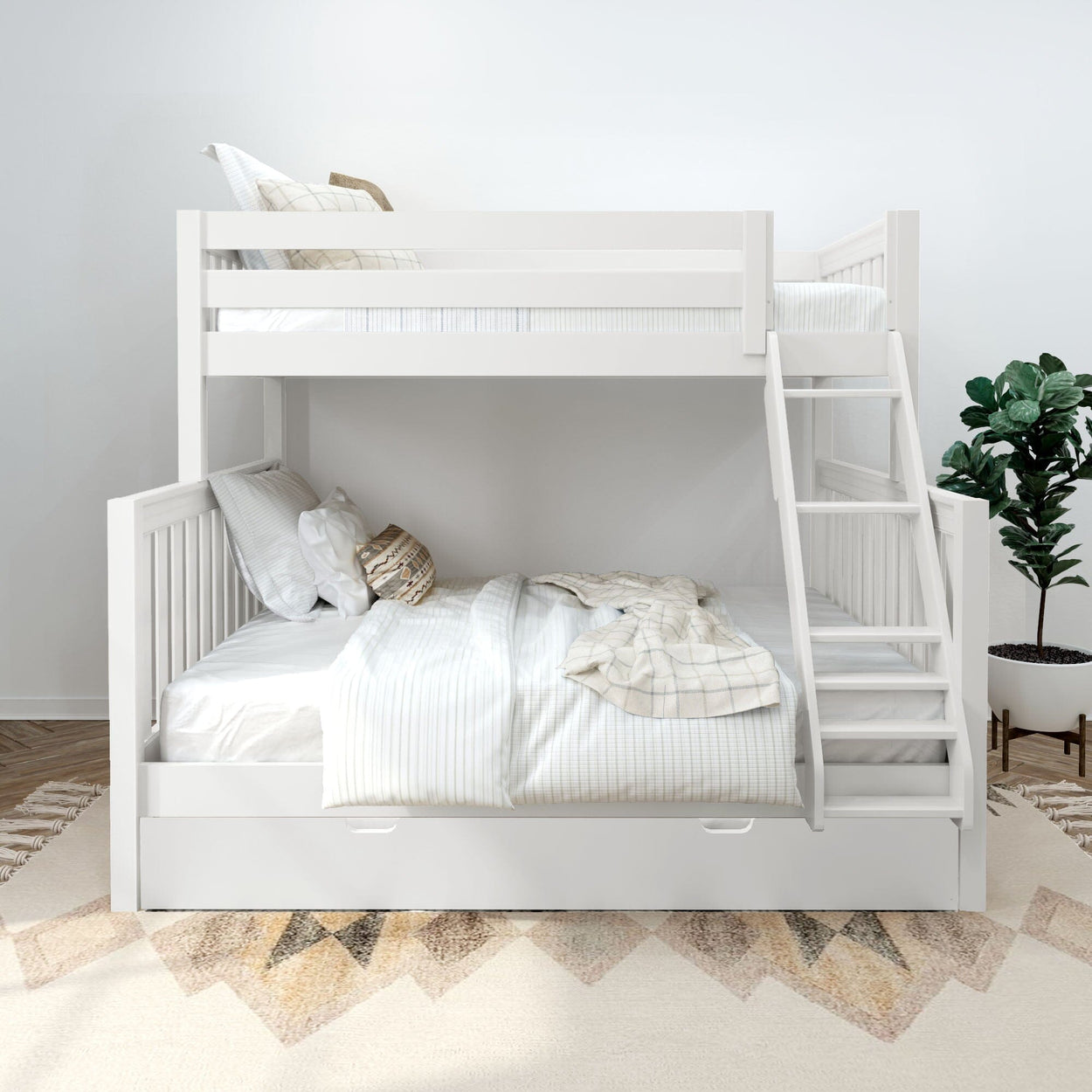 White wooden twin-over-full bunk bed with ladder and storage trundle, neutral striped bedding, decorative pillows and potted plant in a modern space-saving kids' bedroom