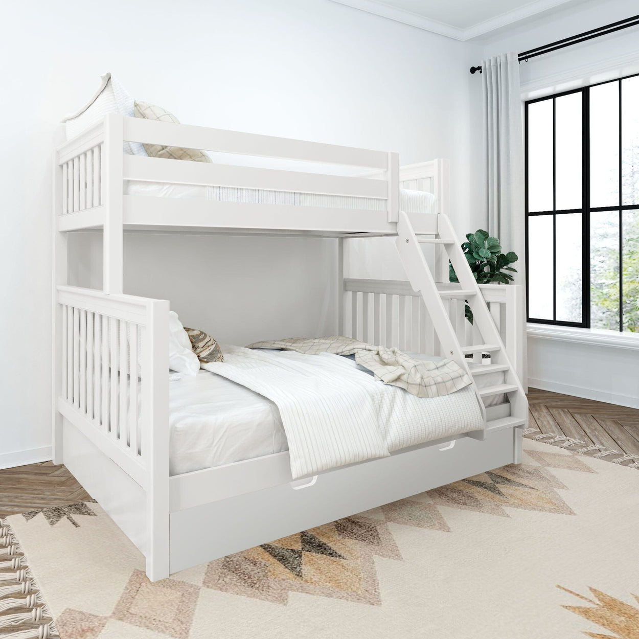 White wooden twin-over-full bunk bed with ladder and pull-out trundle storage in a bright modern kids' bedroom with patterned rug and large window