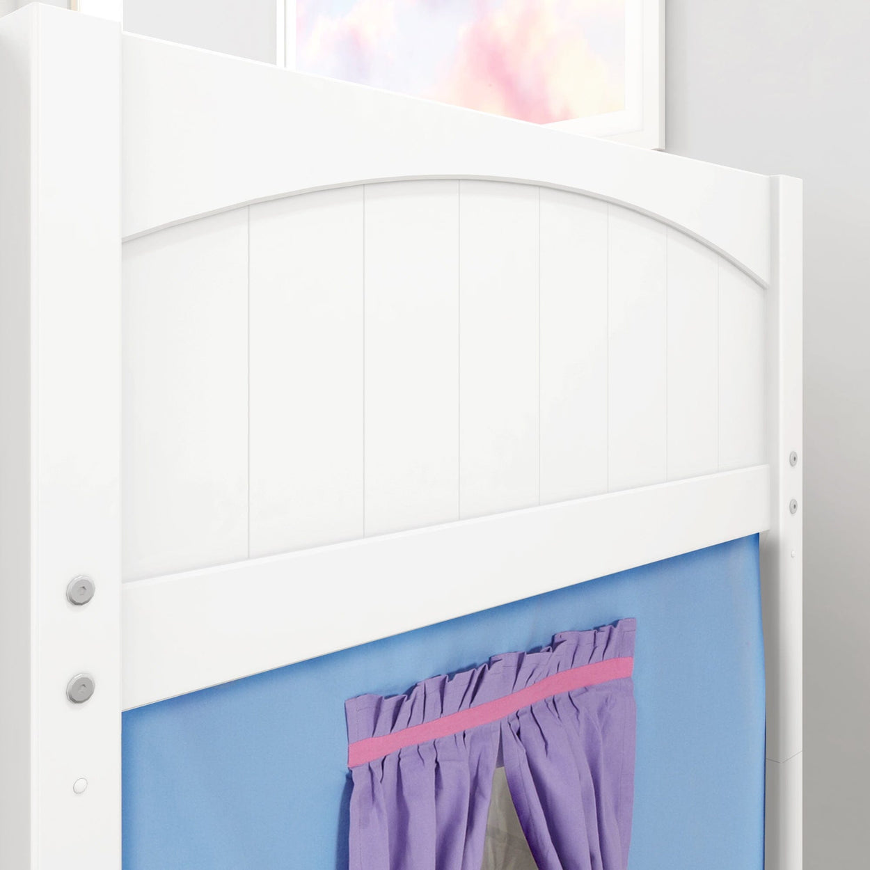 White wooden bed frame with a blue and purple curtain in a children's bedroom.