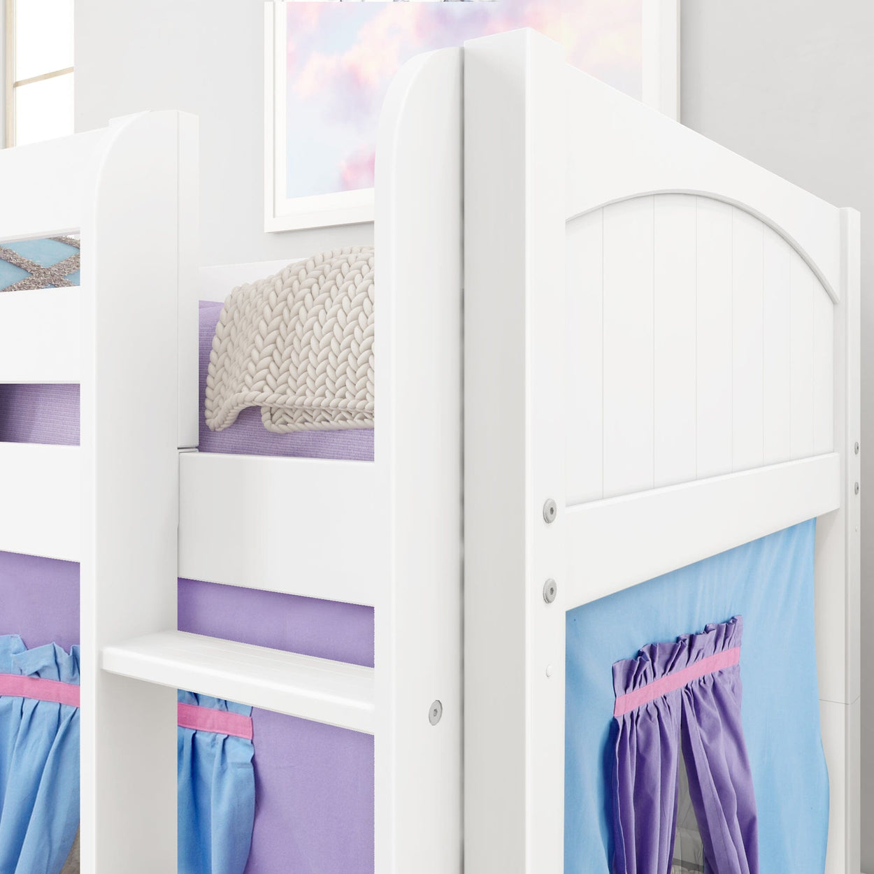 White bunk bed with colorful lavender and blue curtains, featuring a knitted blanket, ideal for a modern kids’ bedroom setup.
