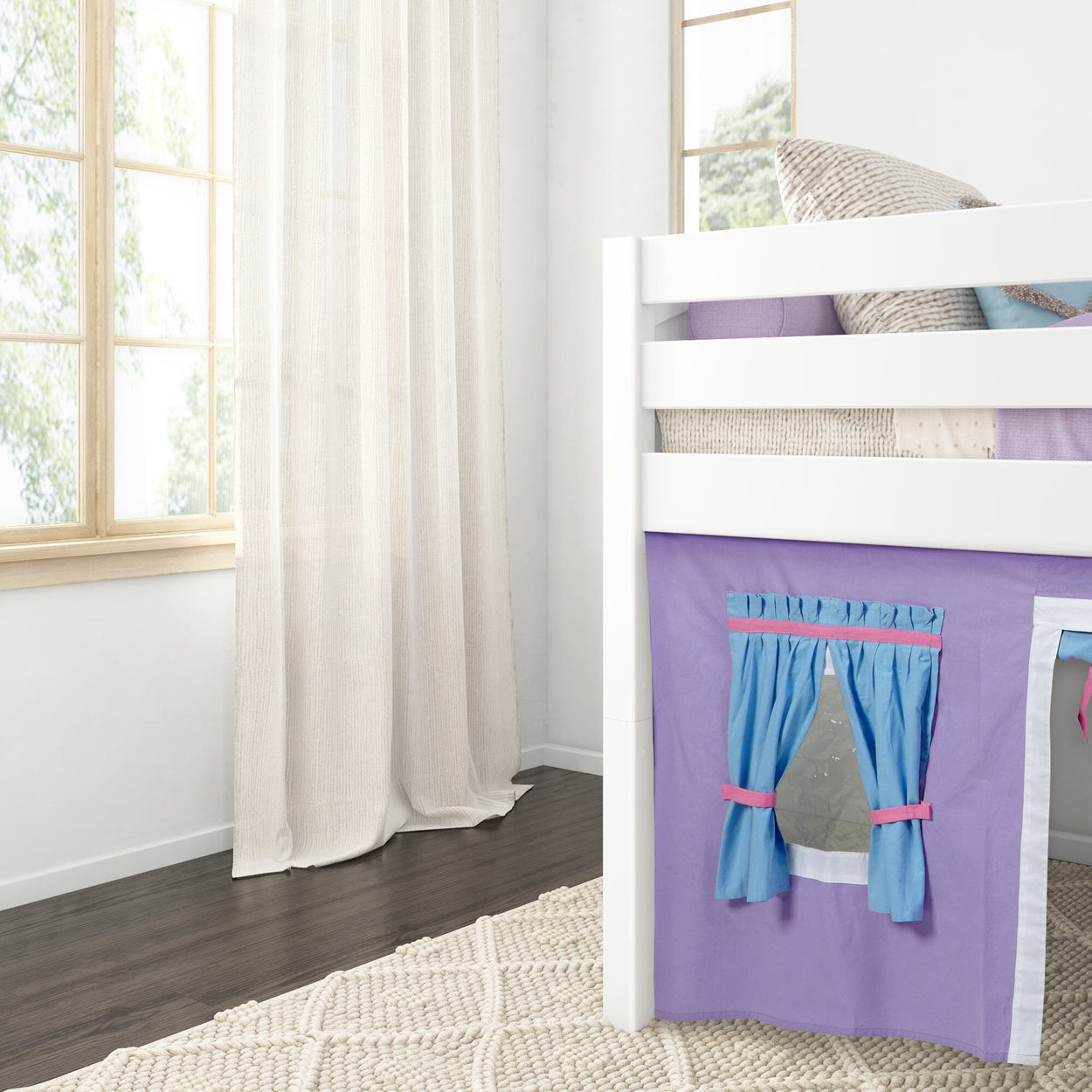 Kids bedroom with loft bed, cozy pillows, and decorative curtains in a bright and airy space.