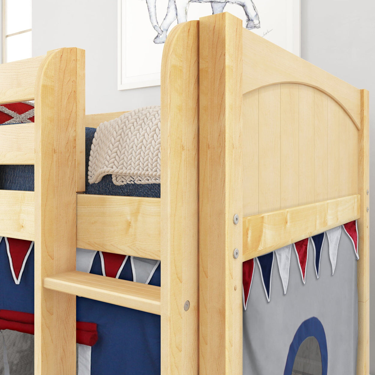 Wooden bunk bed with ladder and decorative fabric, featuring red and blue details.