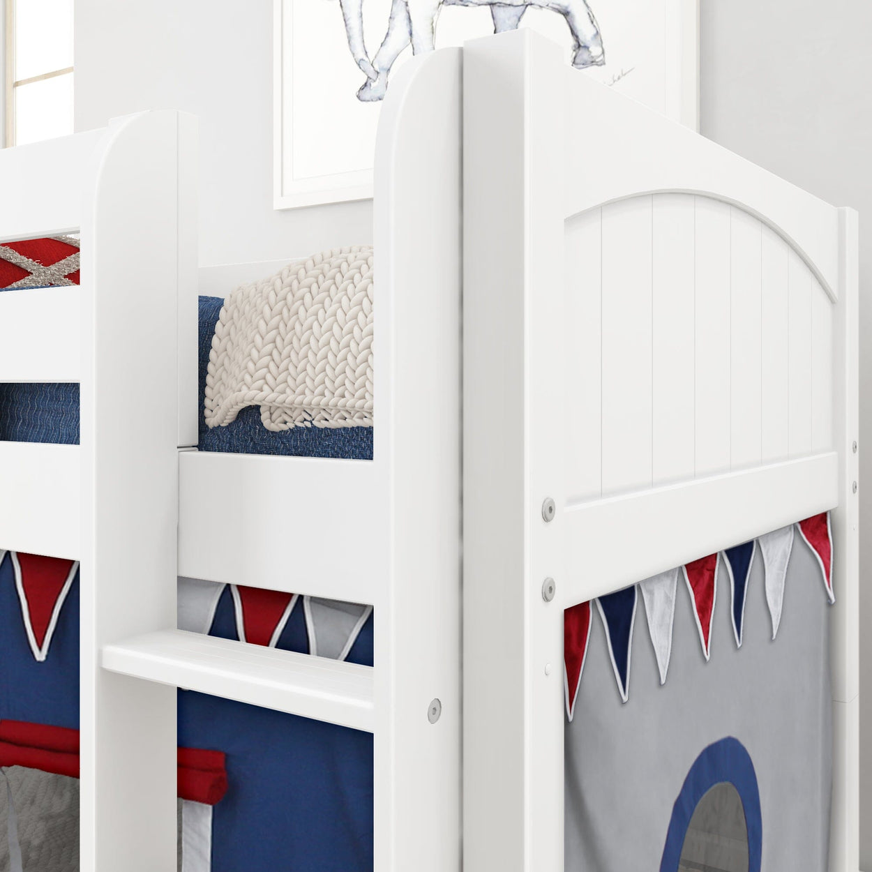 White children's bunk bed with colorful fabric tent and cozy knitted blanket.