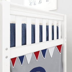 White baby crib with colorful triangle bunting decorations and navy blue blanket.