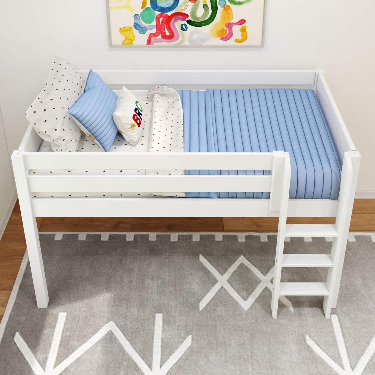 White wooden loft bed with ladder, blue bedding, and colorful wall art in children's room.