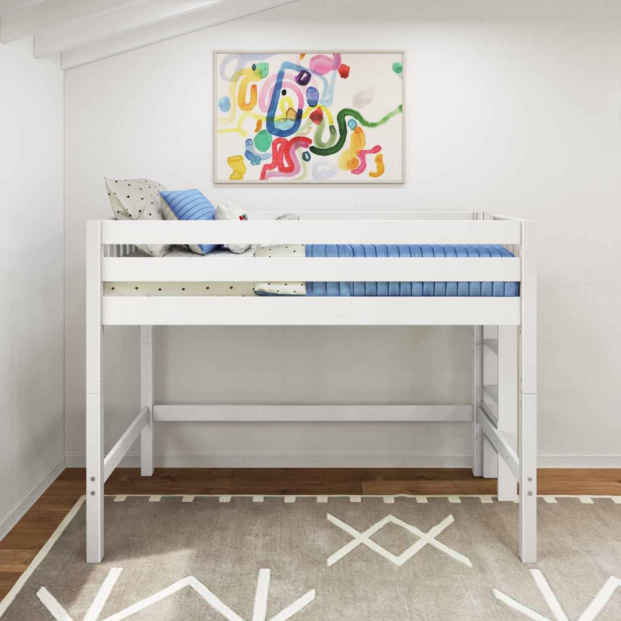 Modern white twin loft bed with guardrails, blue bedding and pillows in children's bedroom, colorful abstract wall art, patterned rug and hardwood floor