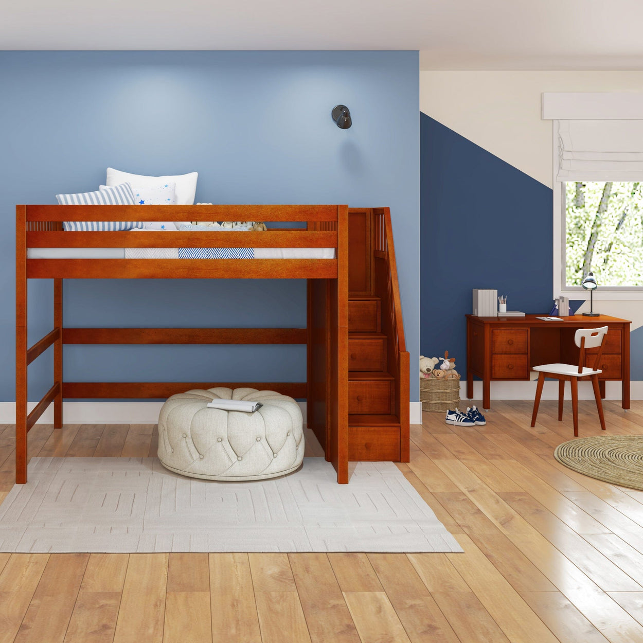 Loft bed with built-in stairs and study desk in a modern children's bedroom with blue accent wall.