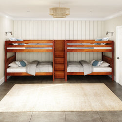 Wooden quadruple bunk beds with gray bedding in a modern bedroom interior with white shiplap walls and a neutral area rug.