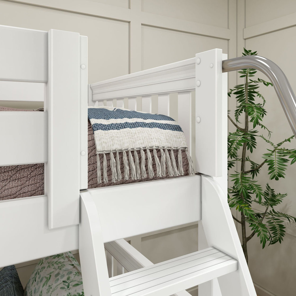 White bunk bed with ladder and decorative blanket in modern bedroom setup with plant.