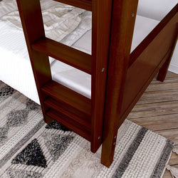 Close-up of a wooden bunk bed ladder in a modern bedroom with geometric rug.