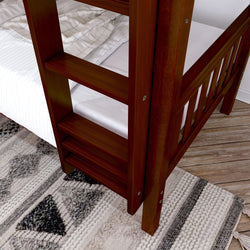 Dark wood bunk bed ladder and bedding on wooden floor with patterned rug in cozy bedroom.
