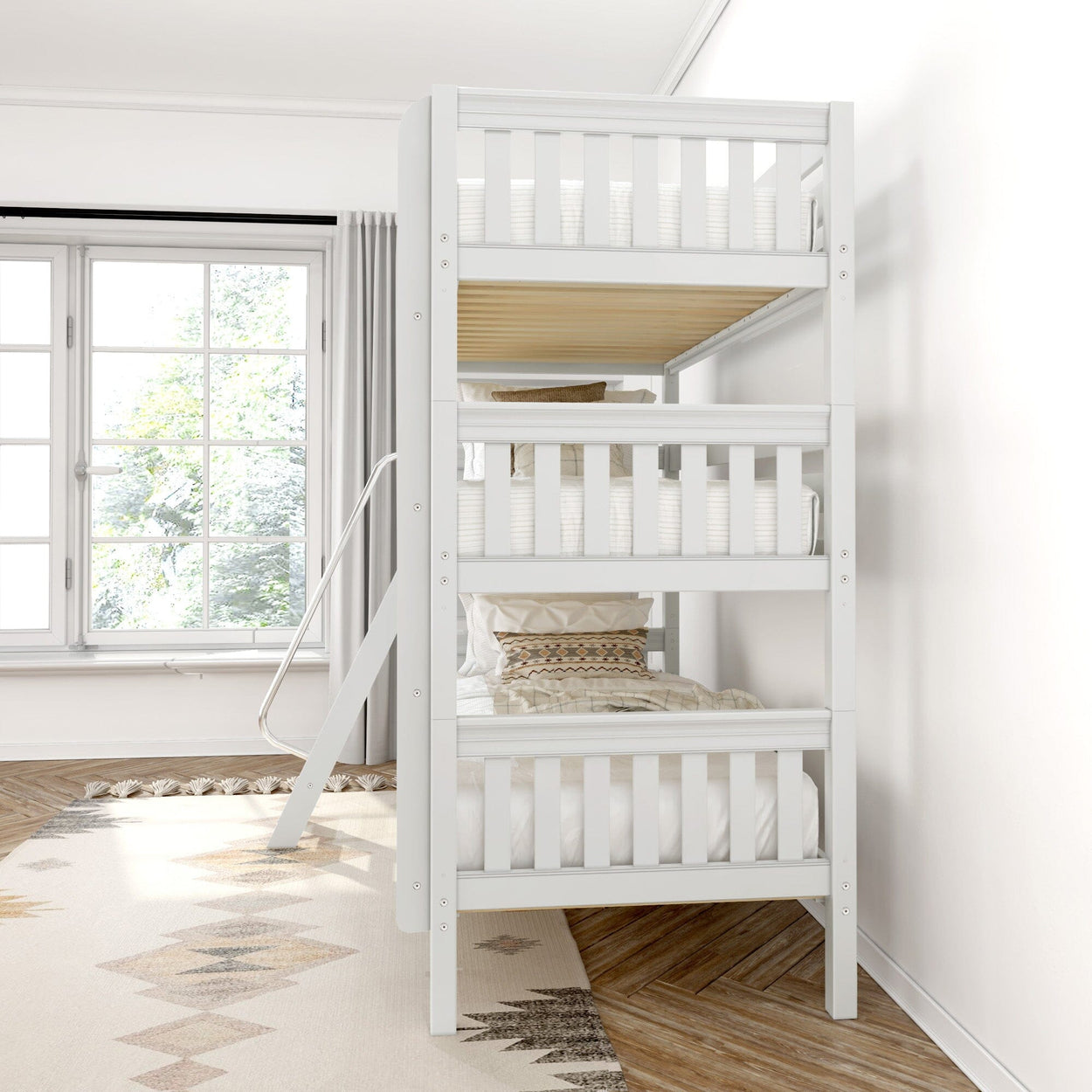 White wooden triple bunk bed with cozy pillows in a bright children's bedroom with large window.