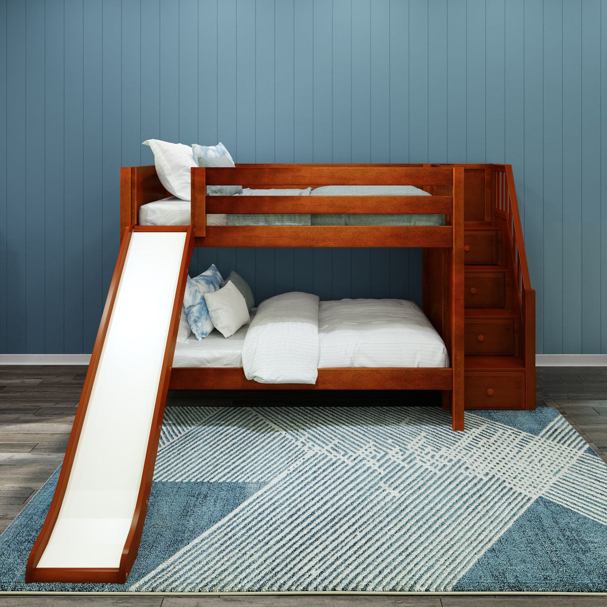Wooden bunk bed with slide and stairs in a modern kids' room with blue panel walls and patterned rug.