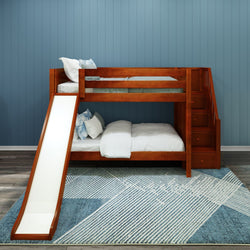 Wooden bunk bed with slide and stairs in a modern kids' room with blue panel walls and patterned rug.