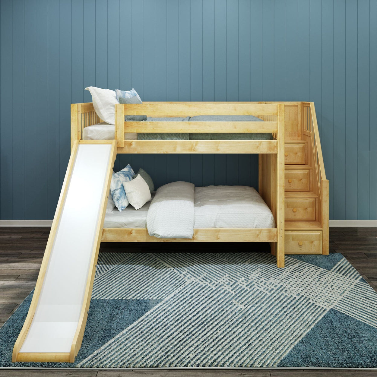 Kids wooden bunk bed with slide and stairs on a blue geometric rug.