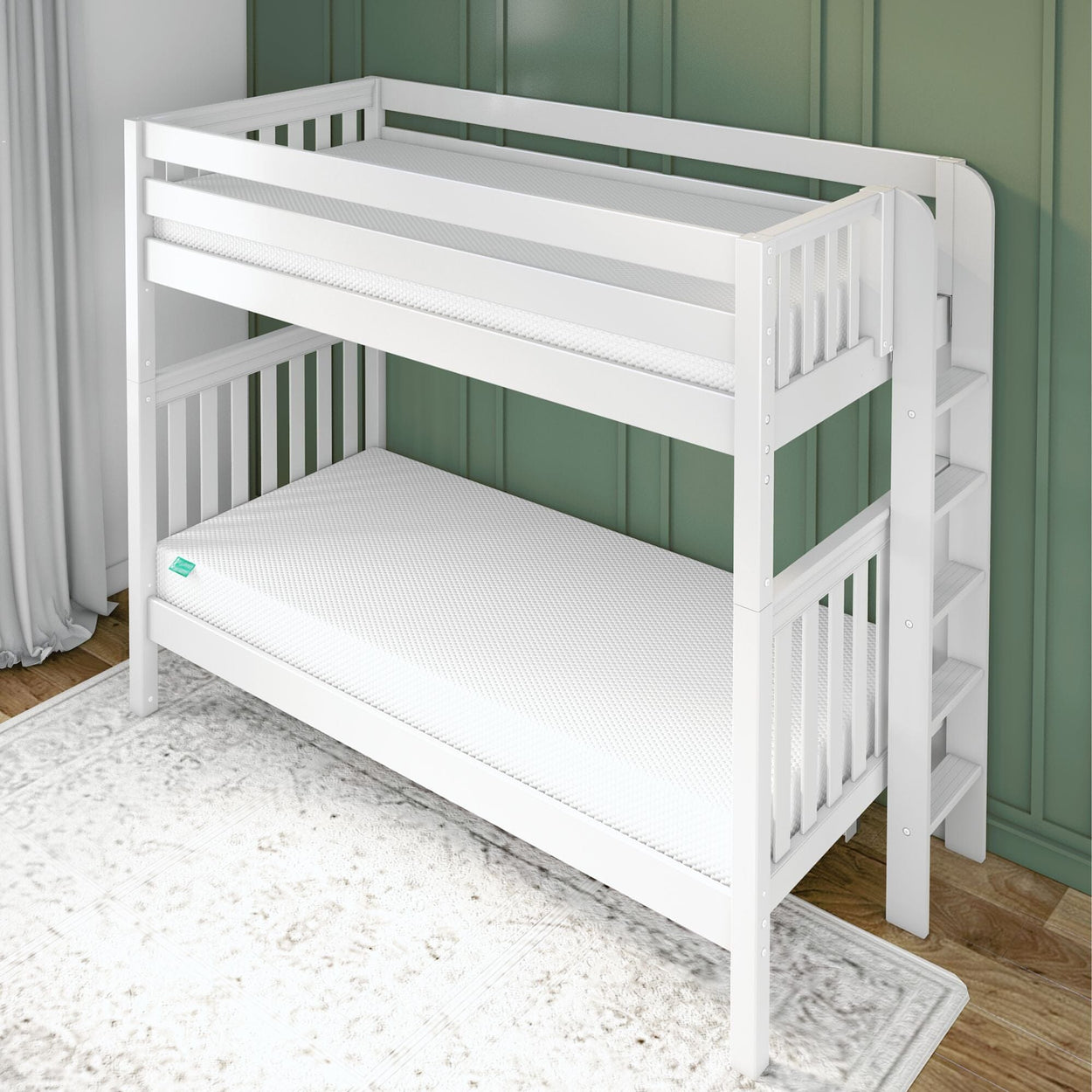 White wooden bunk bed with safety railing and ladder against a green wall in a child’s bedroom.