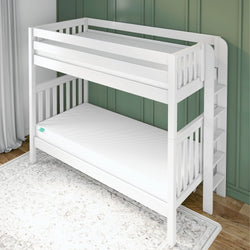 White wooden bunk bed with safety railing and ladder against a green wall in a child’s bedroom.