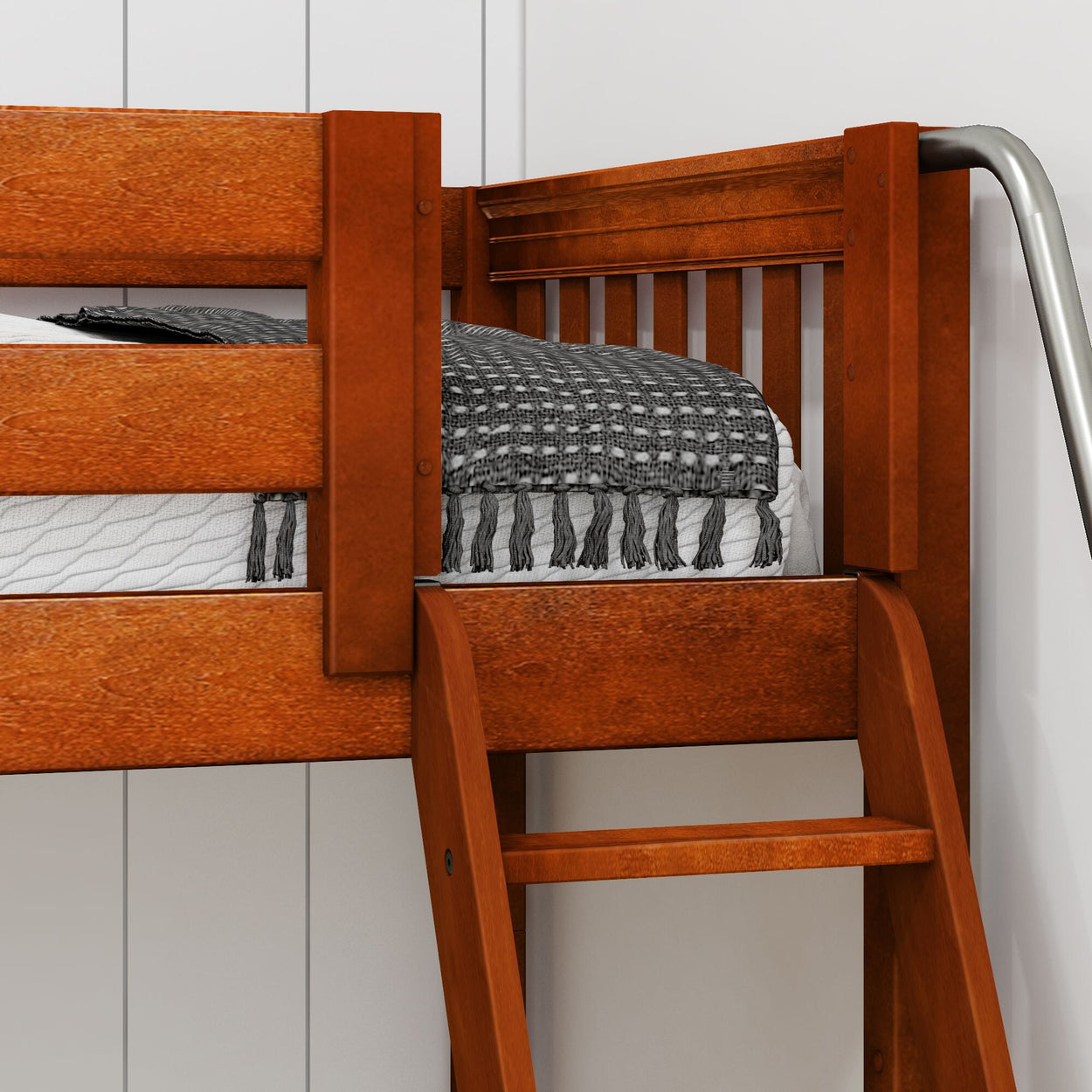 Wooden loft bed with ladder and blanket against a white wall.