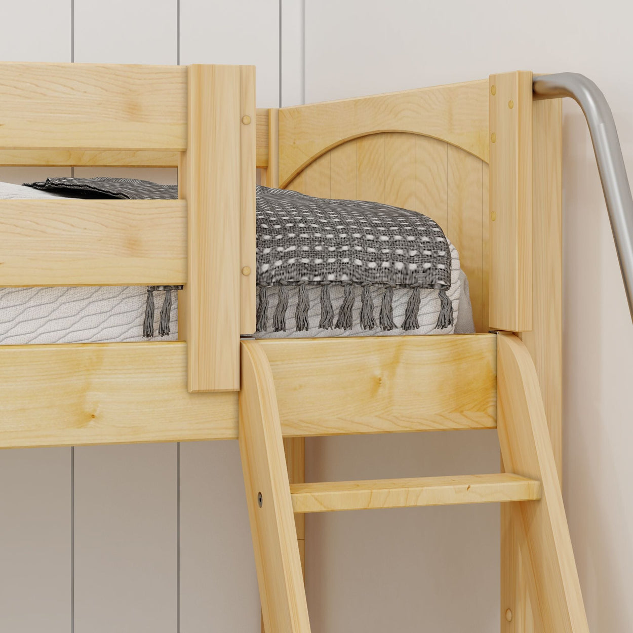 Wooden bunk bed platform with gray patterned blanket and mattress in a cozy bedroom setting.