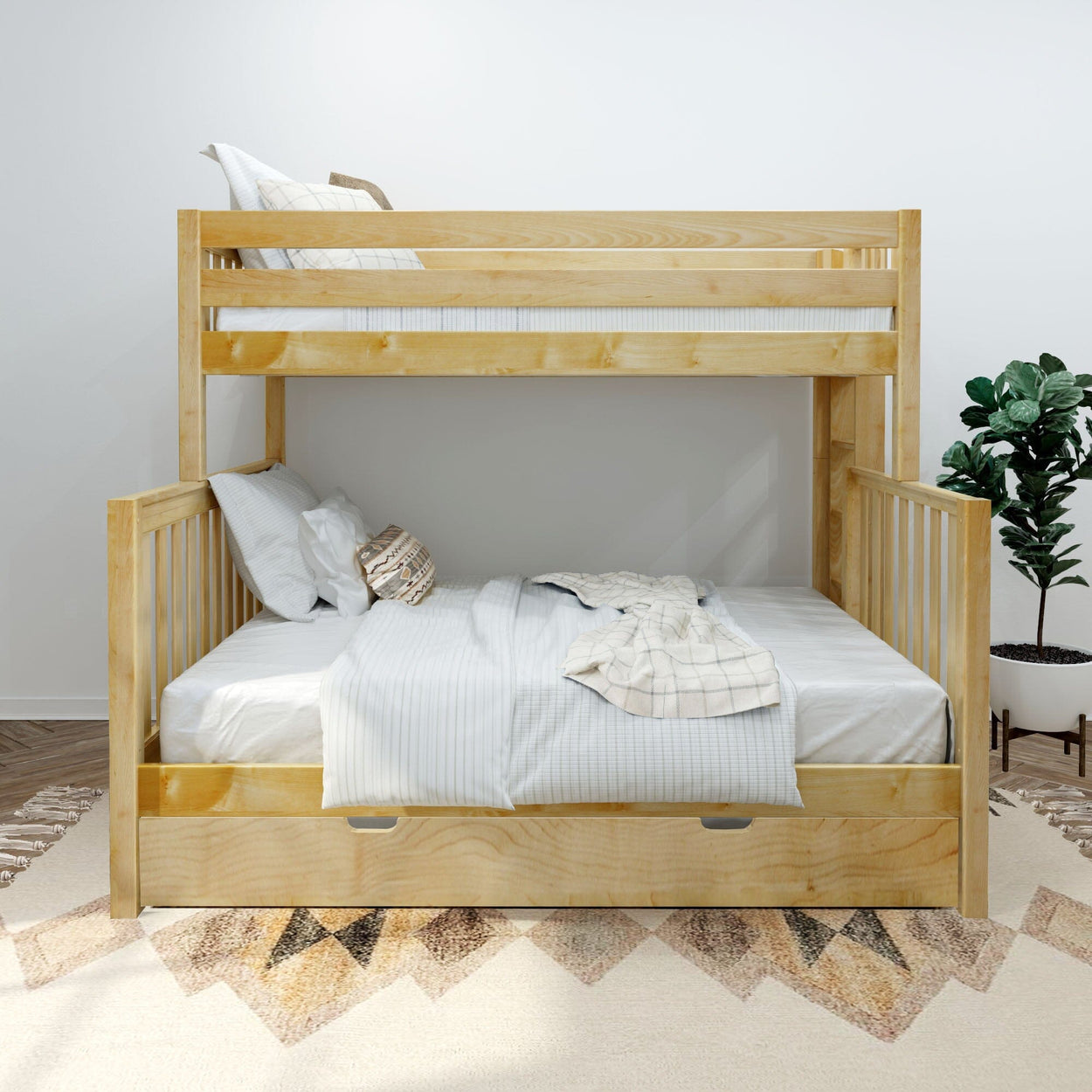 Light natural wood twin-over-full bunk bed with under-bed storage drawer, white linens and potted plant in modern bedroom